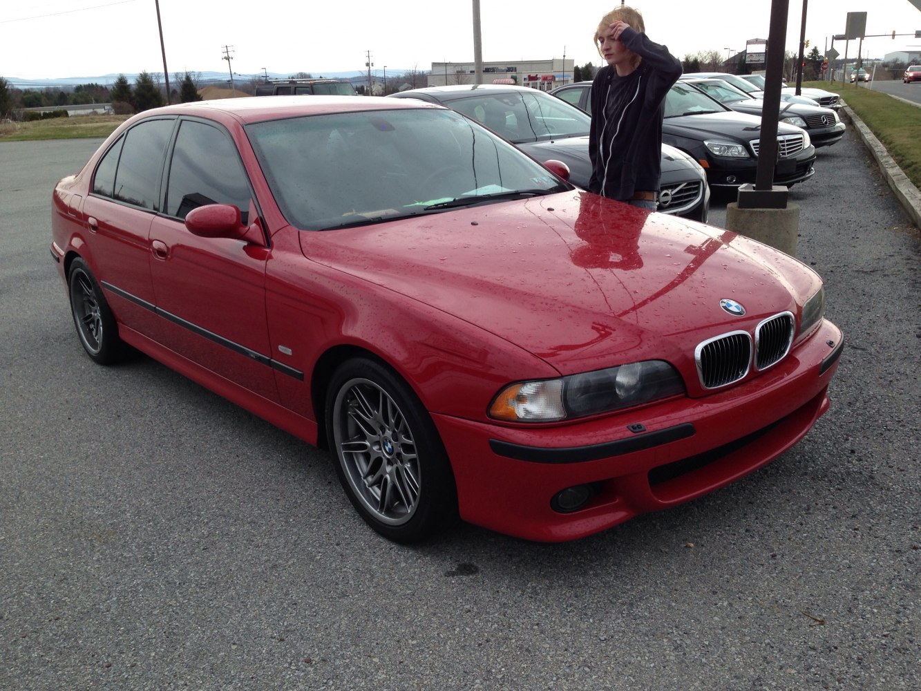 Red sedan with alloy wheels and black bumper trim