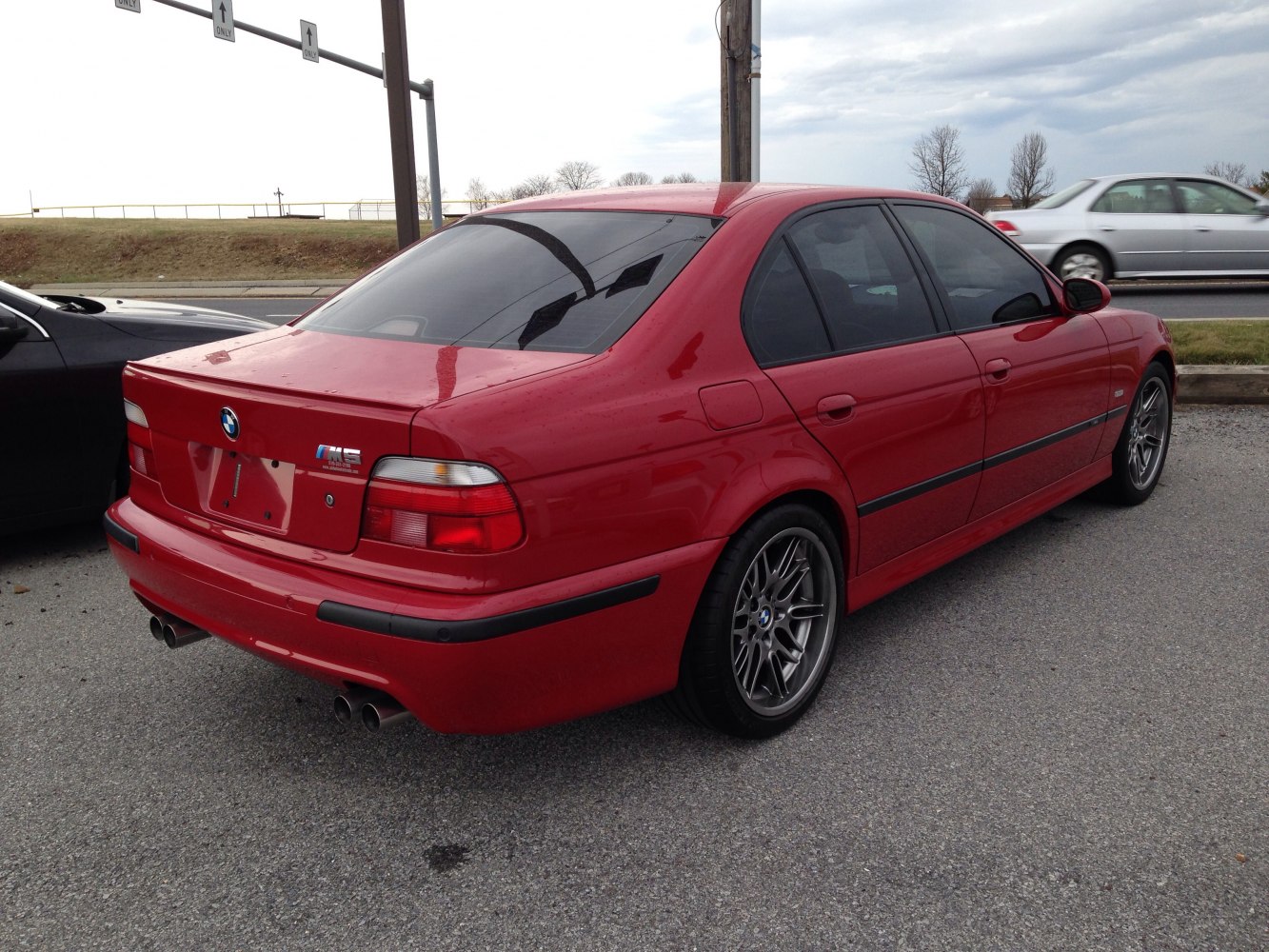 Rear side view with quad exhaust and alloy wheels