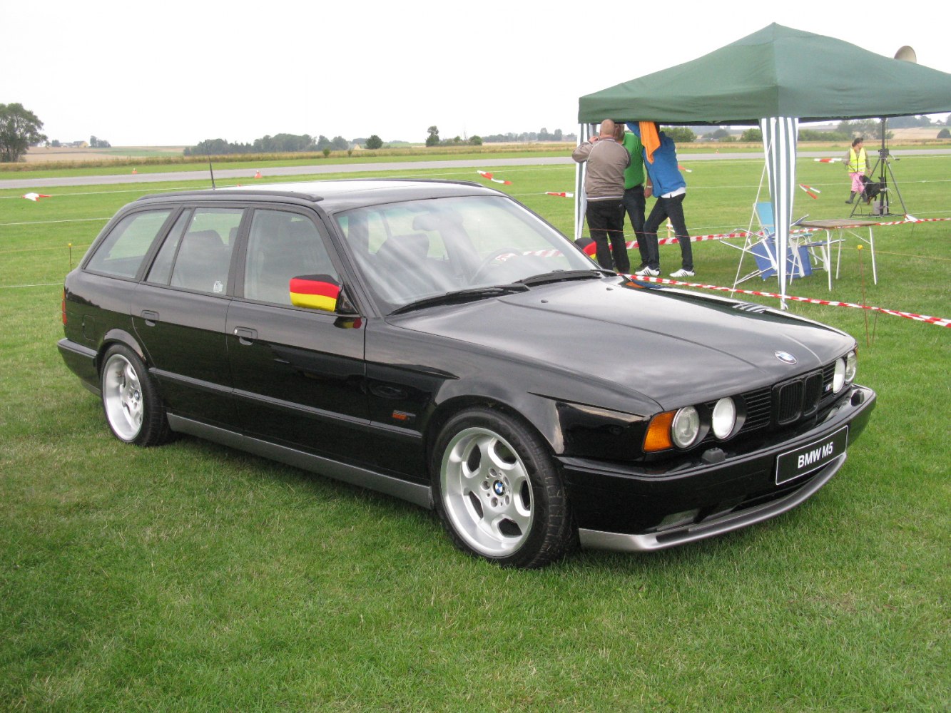 Black performance touring wagon with German flag mirror accents and alloy wheels