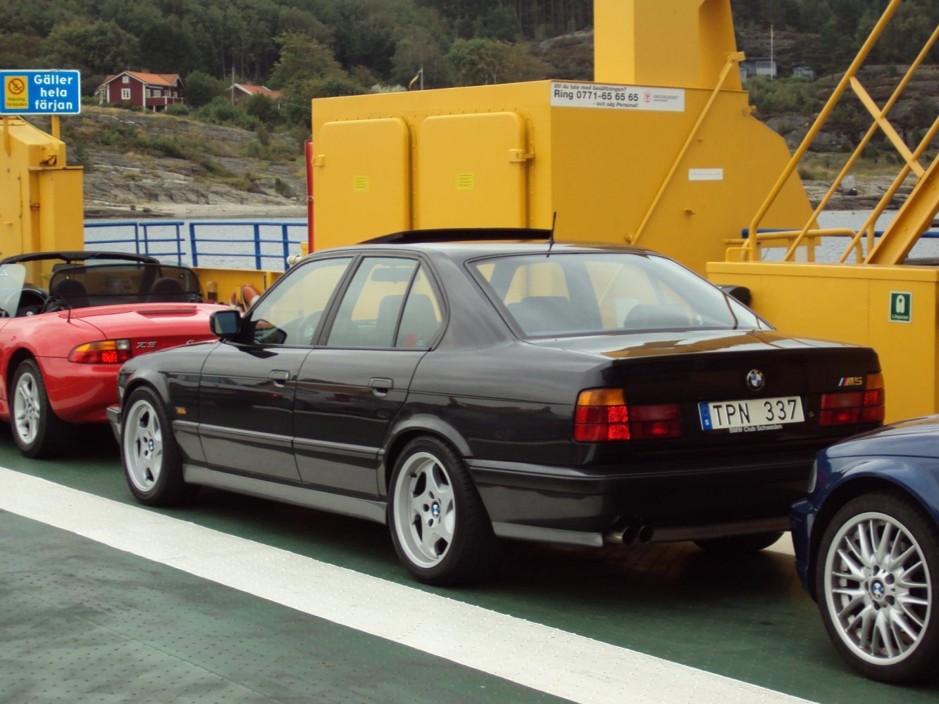 Rear side view of classic sedan with signature wheels and taillights