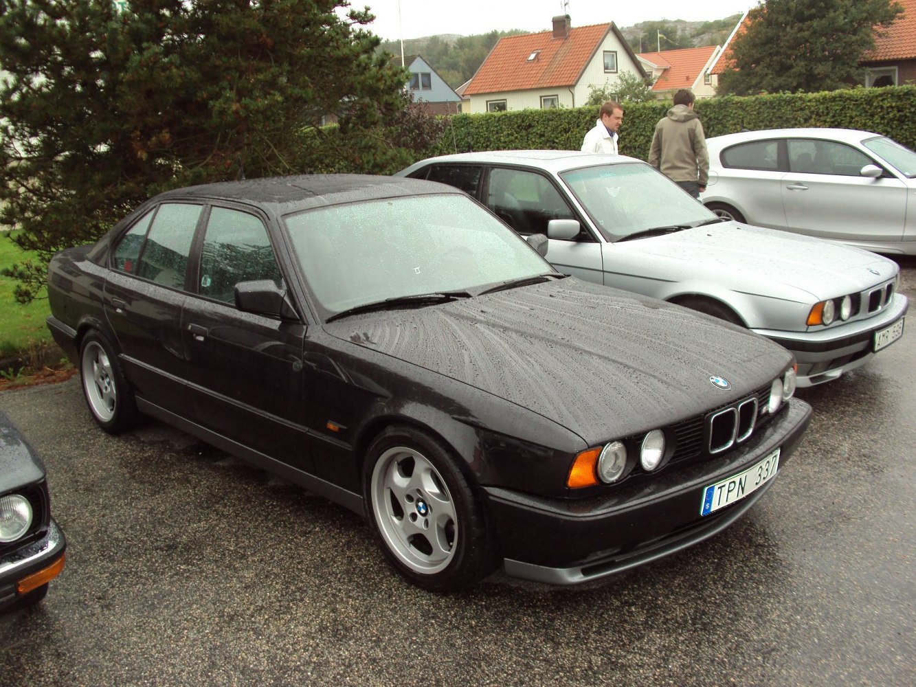 Dual round headlights and five-spoke alloy wheels on a vintage sedan
