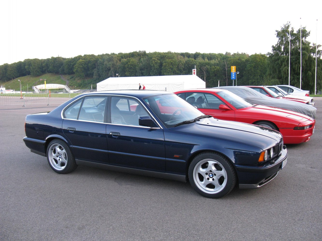 Side profile of a classic BMW E34 M5 with distinct alloy wheels