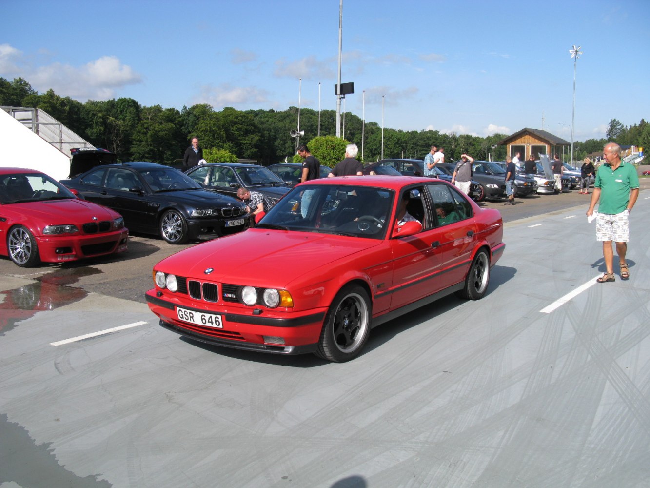 Classic red sports sedan with four round headlights and black wheels
