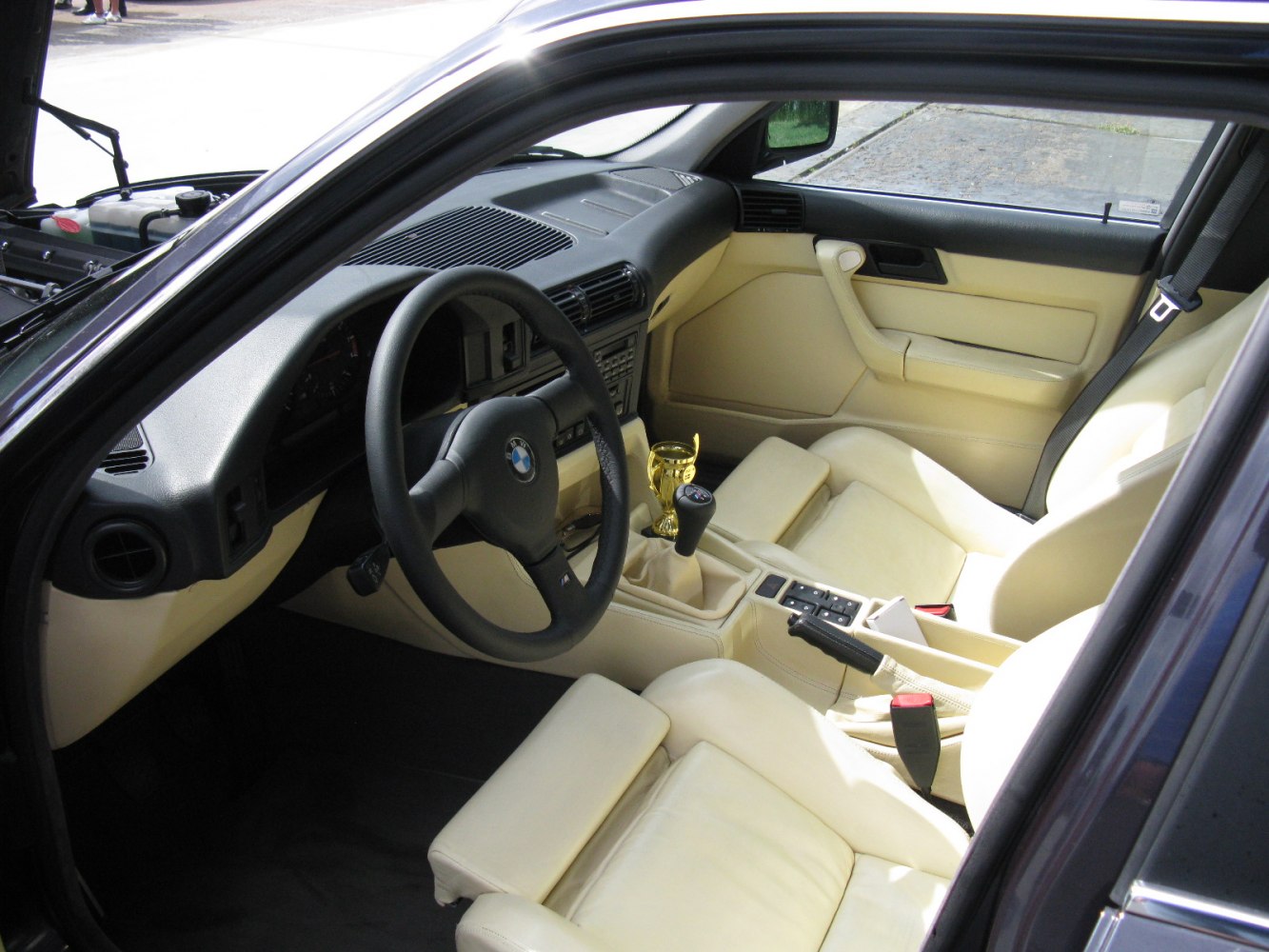 Beige leather interior with manual gear shift and vintage dashboard