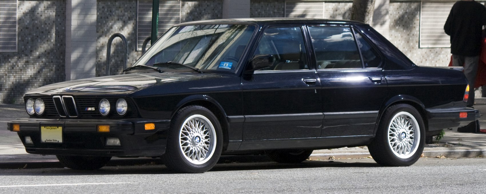 Classic vintage sedan with quad round headlights and mesh alloy wheels