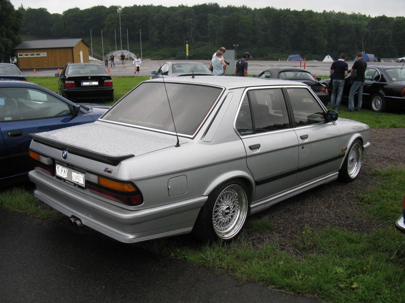 Silver sedan with rear spoiler and mesh wheels