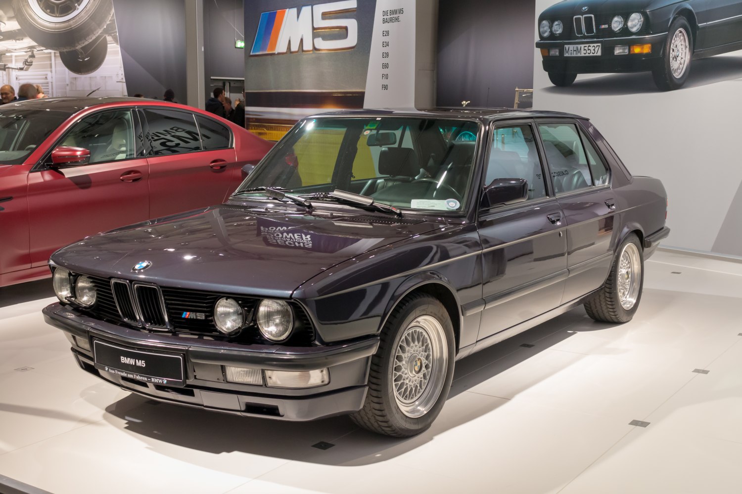 Front three-quarter view of classic sedan with quad headlights and alloy wheels