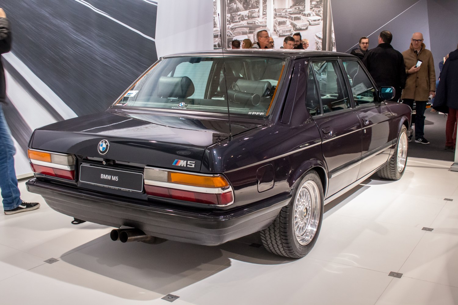 Rear view of a classic high-performance sedan with distinctive taillights and dual exhaust