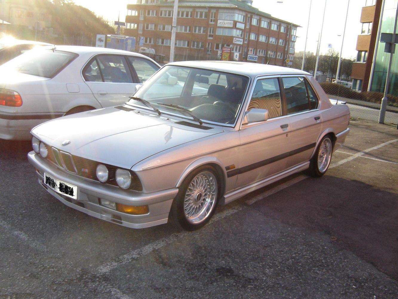 Silver sedan with quad round headlights and intricate alloy wheels