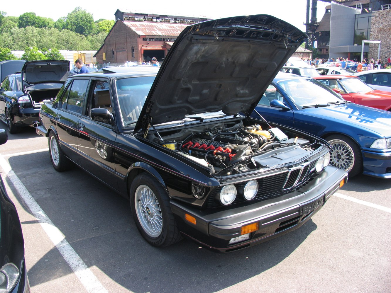 Open hood revealing detailed BMW M5 E28 engine bay
