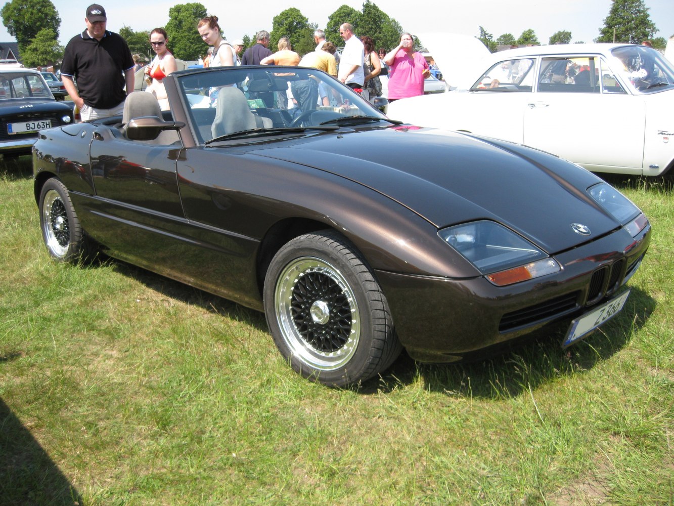 Convertible roadster with retractable doors and black mesh alloy wheels