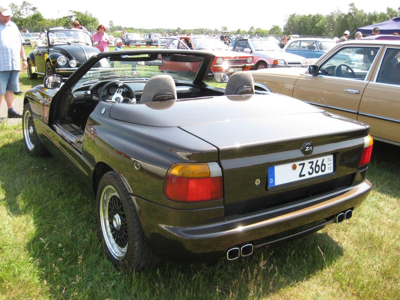 Rear view of a convertible with open doors and dual exhaust