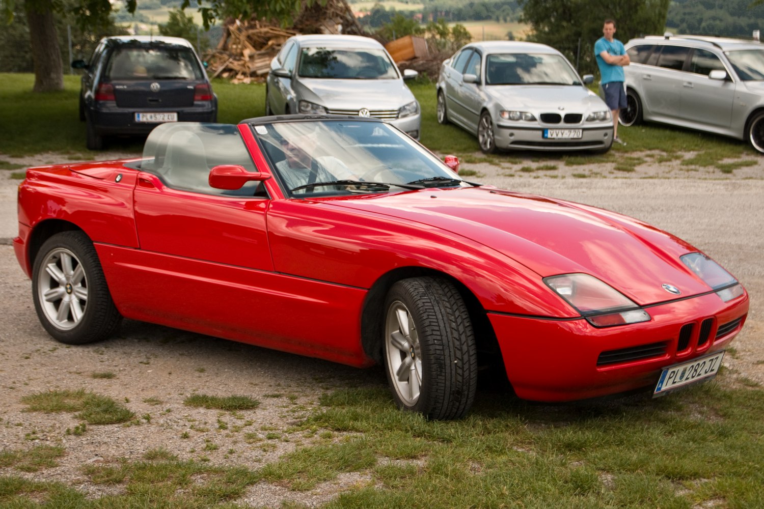 Red convertible roadster with pop-up headlights and smooth body lines