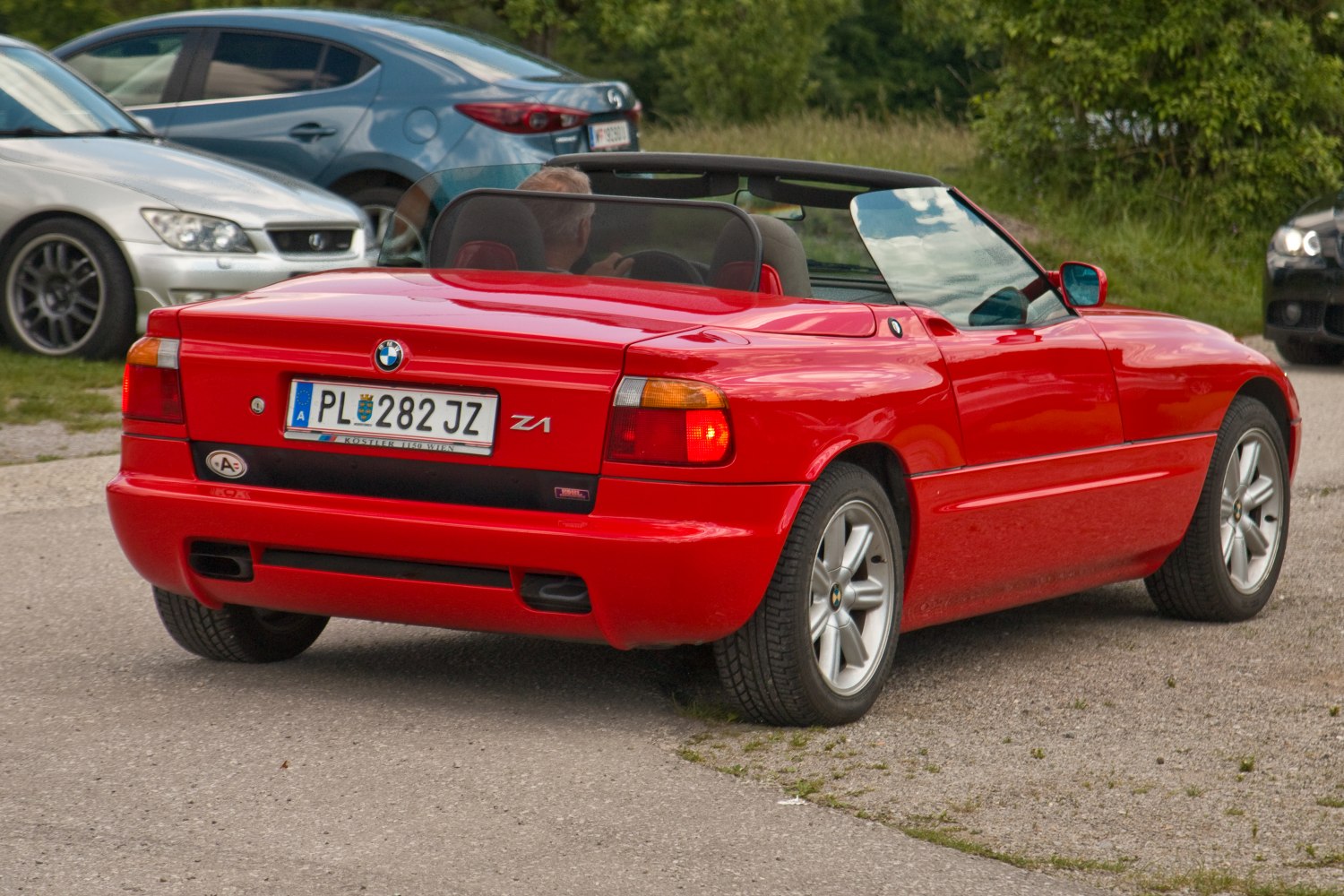 Red convertible with unique rear design and alloy wheels