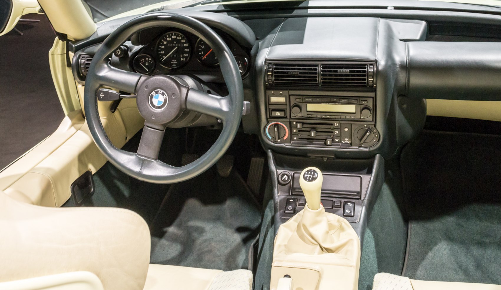 Classic car interior with manual gear shift and round steering wheel