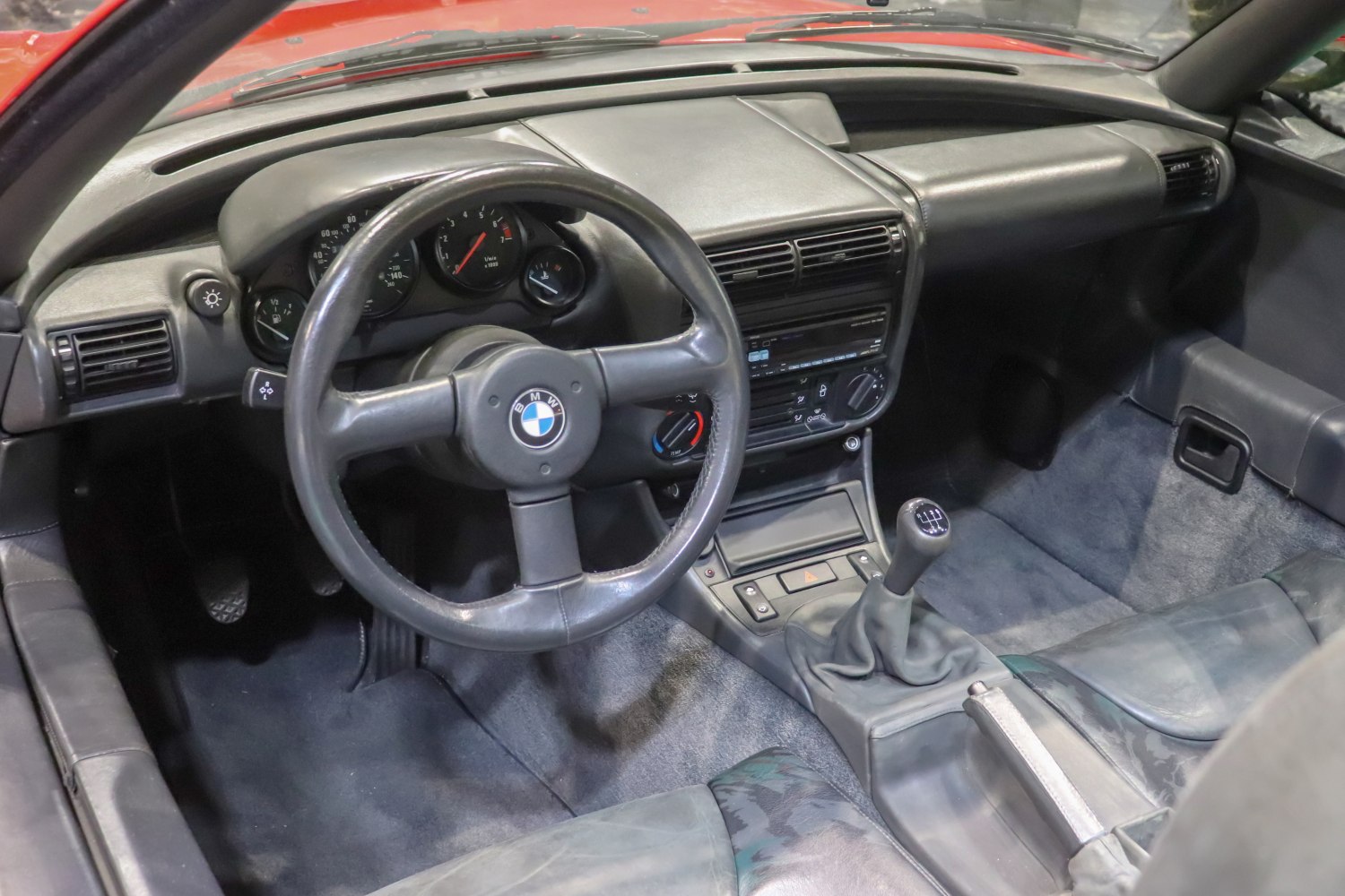 Manual gear shift and classic steering wheel in vintage car interior