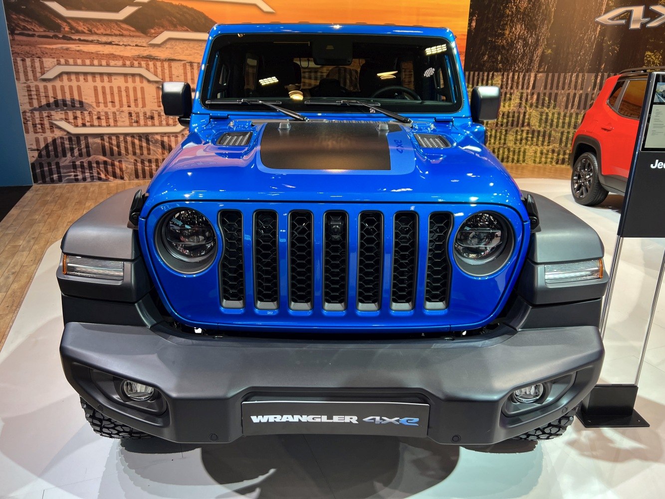 Blue SUV front view with seven-slot grille and round headlights