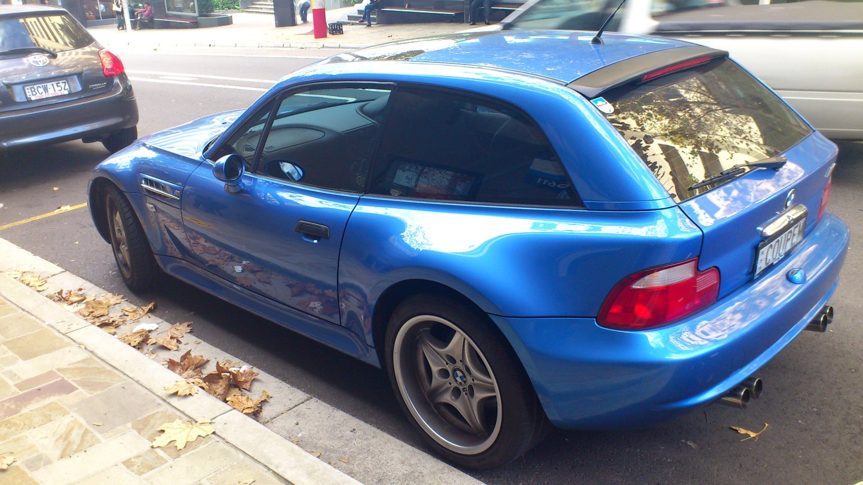 Rear side hatchback view with dual exhaust and smooth sporty curves