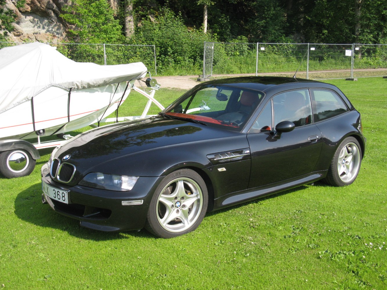 Black compact hatchback with sporty 5-spoke alloy wheels and aggressive front end