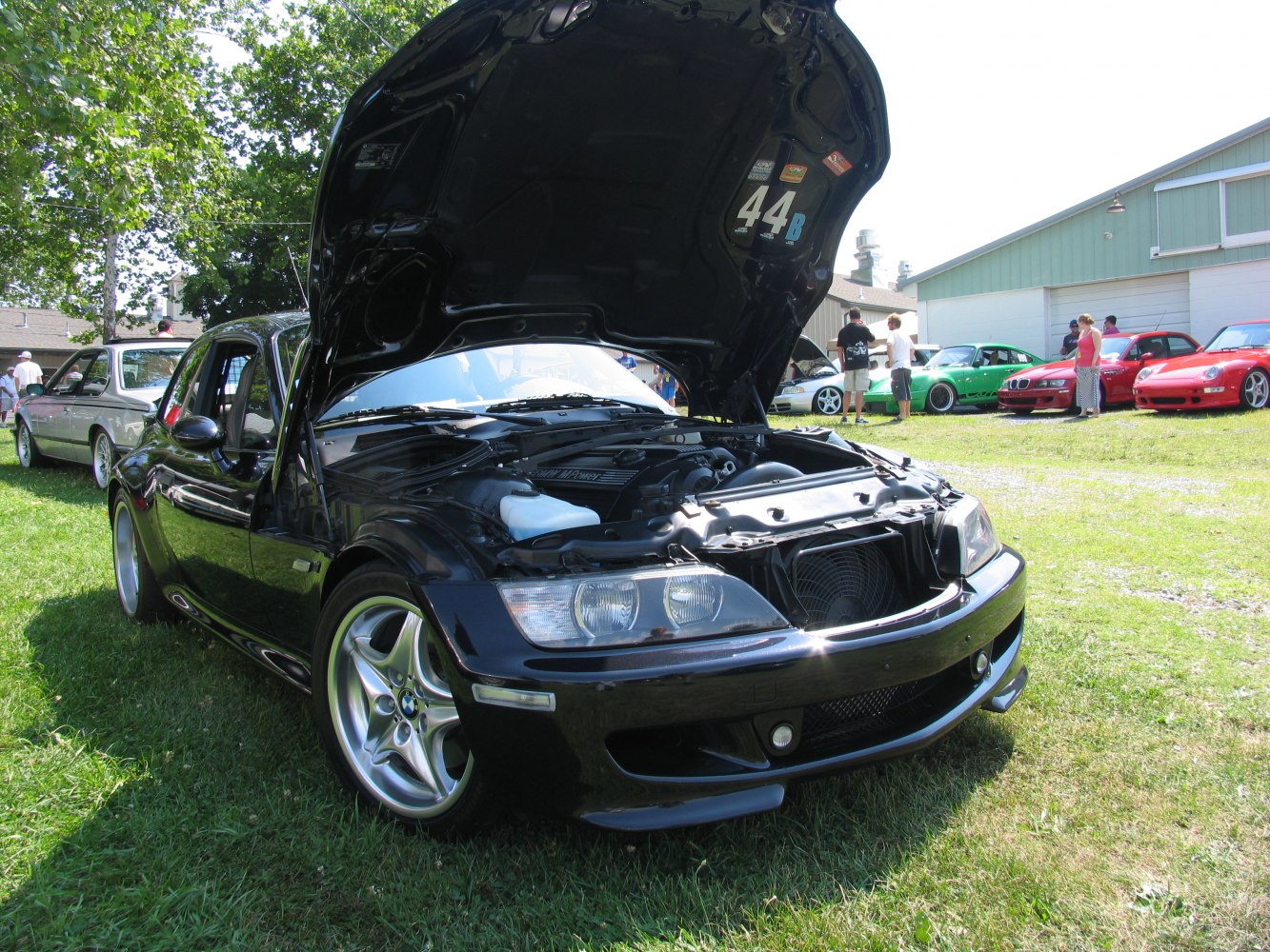 Open hood showing engine bay of a black sports coupe