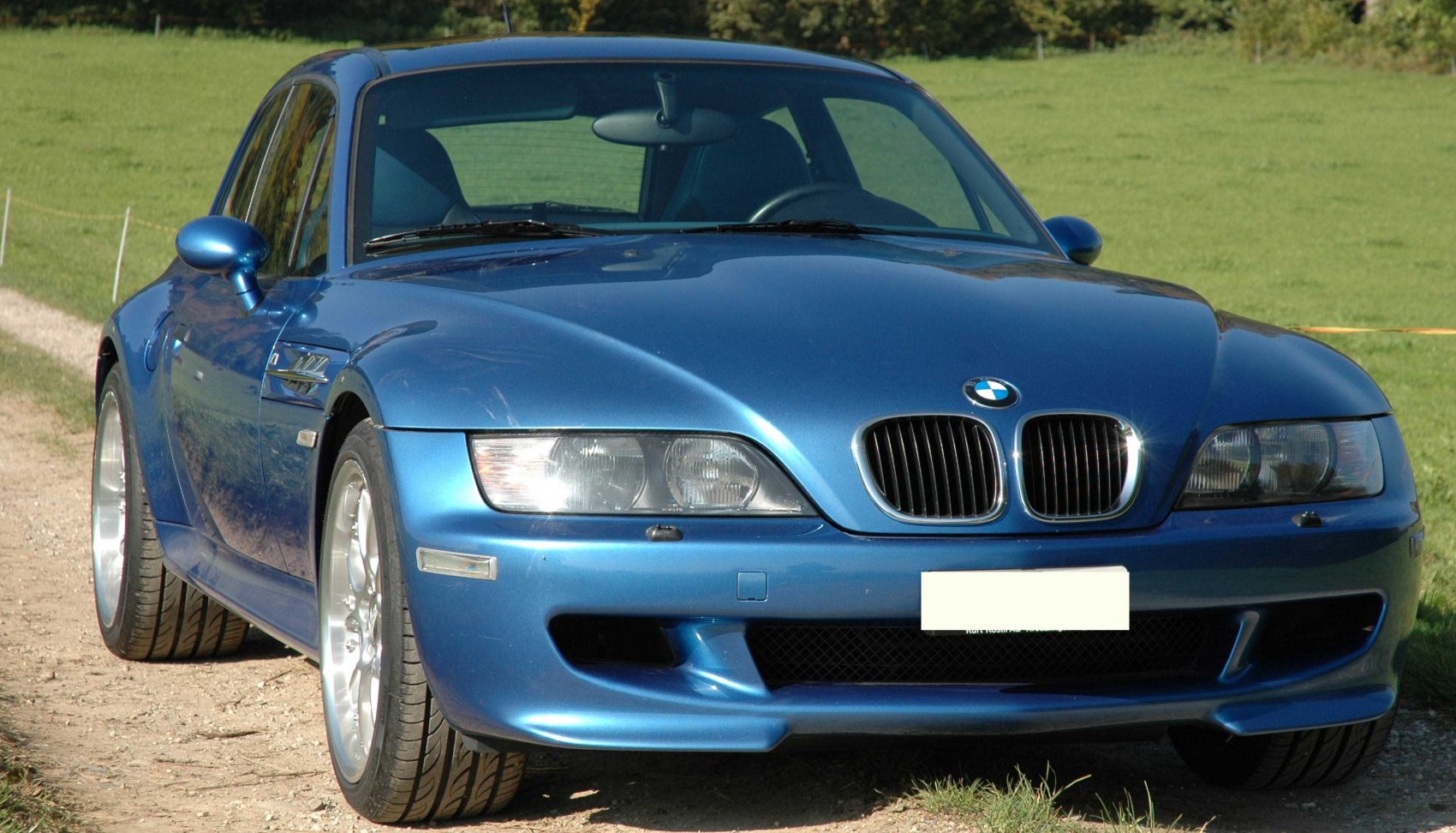 Front view with grille, headlights, and sporty bumper.