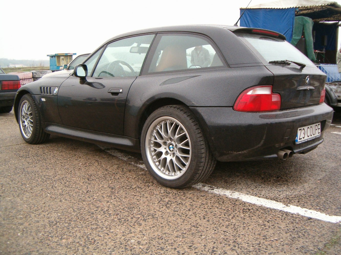 Sporty BMW coupe rear side with alloy wheels