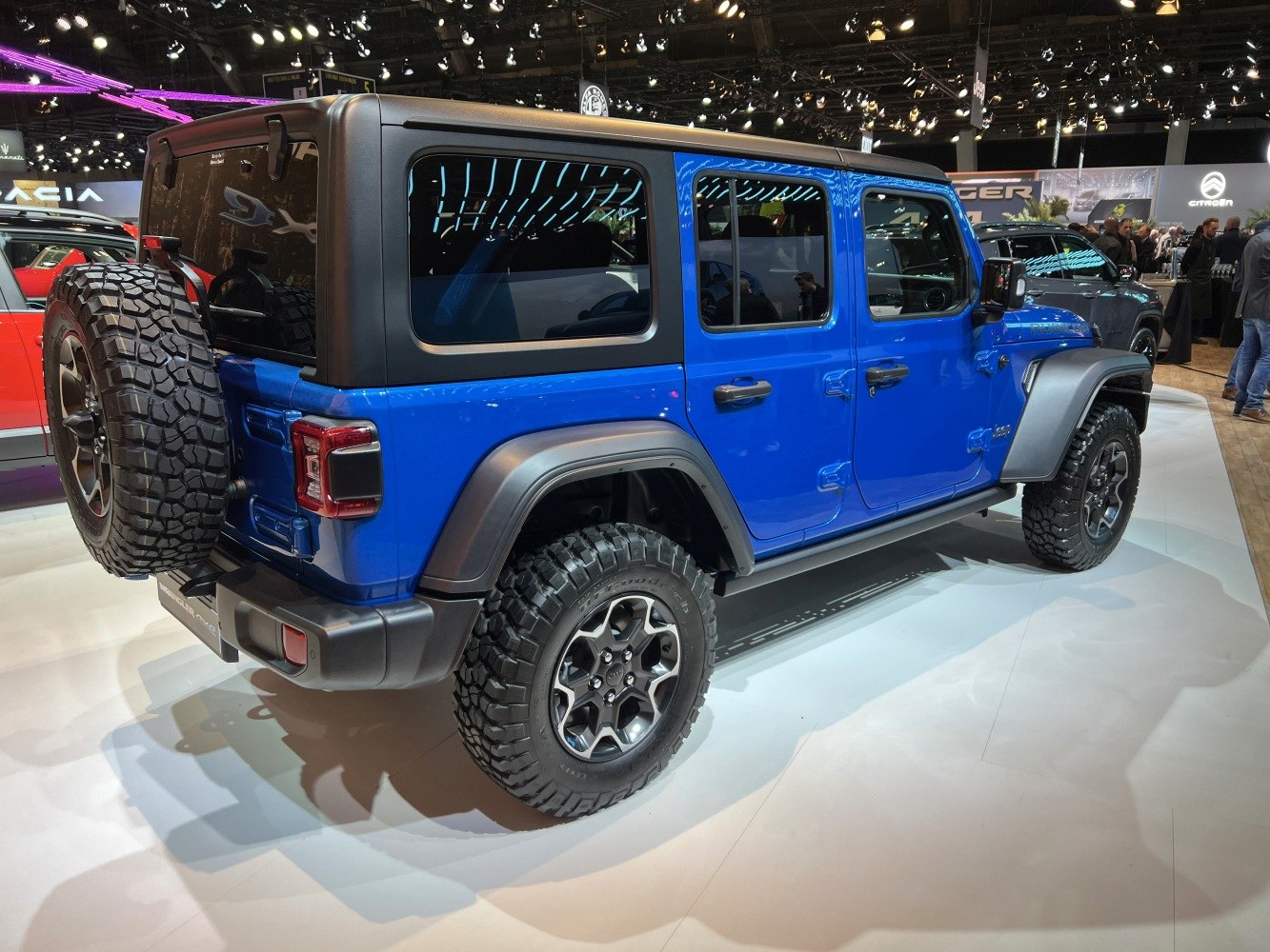 Blue four-door SUV with rugged off-road tires and rear mounted spare tire