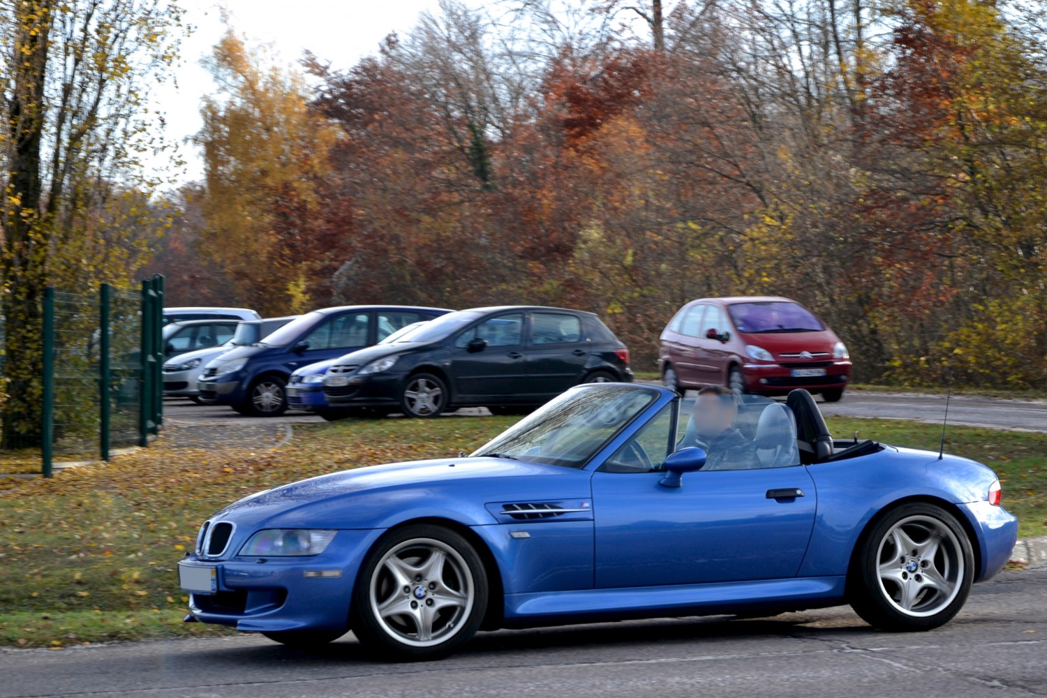 Blue convertible roadster with sporty side profile and alloy wheels