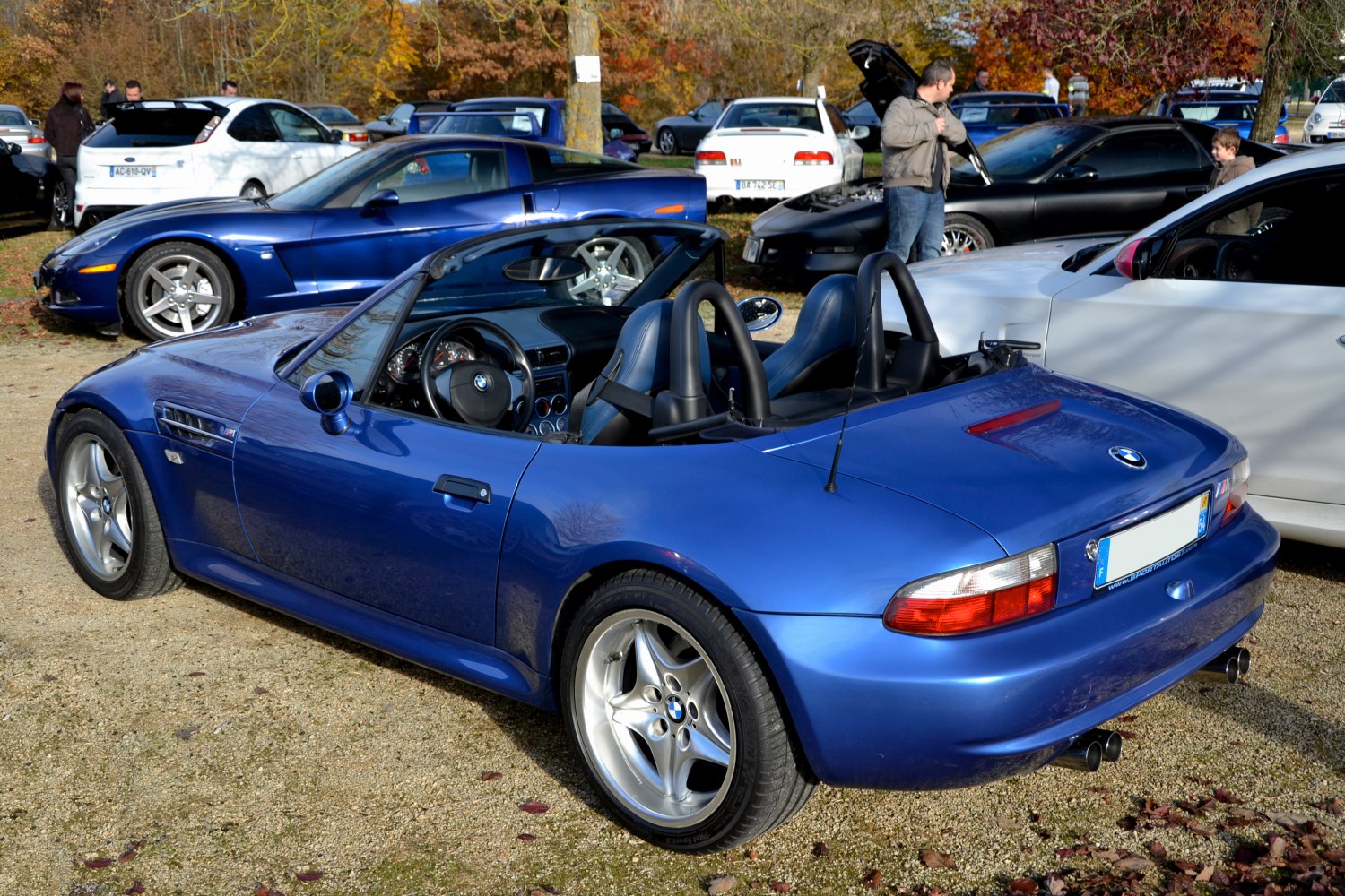 Blue convertible roadster with dual roll bars and open interior