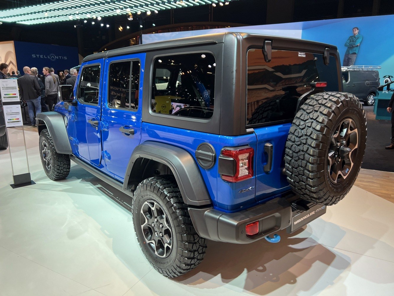 Blue SUV rear side with rugged tires and spare wheel mounted