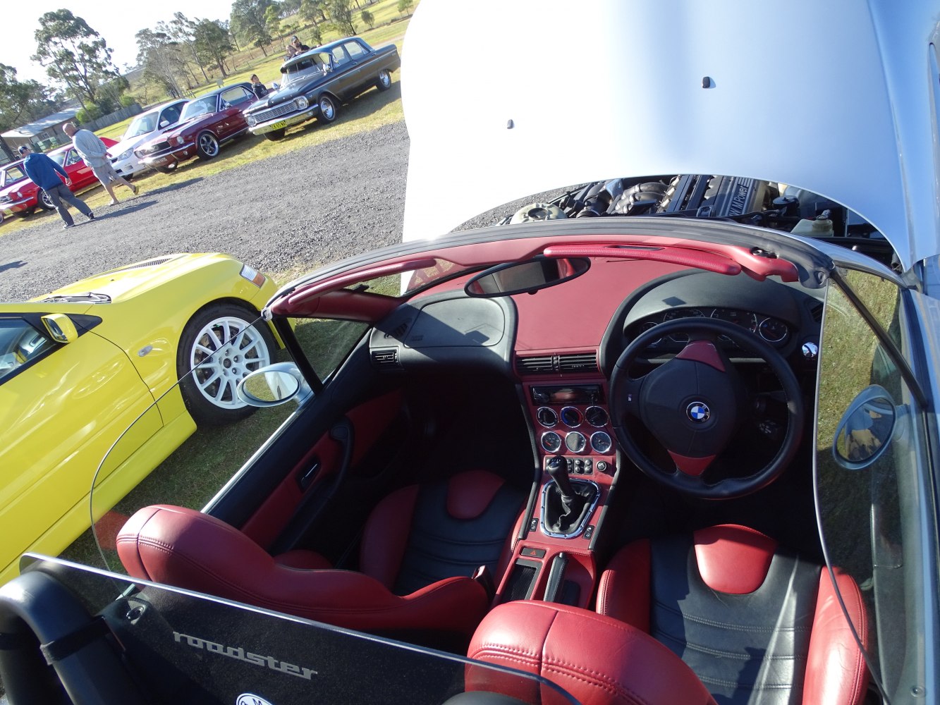 Convertible interior with red leather seats and manual transmission