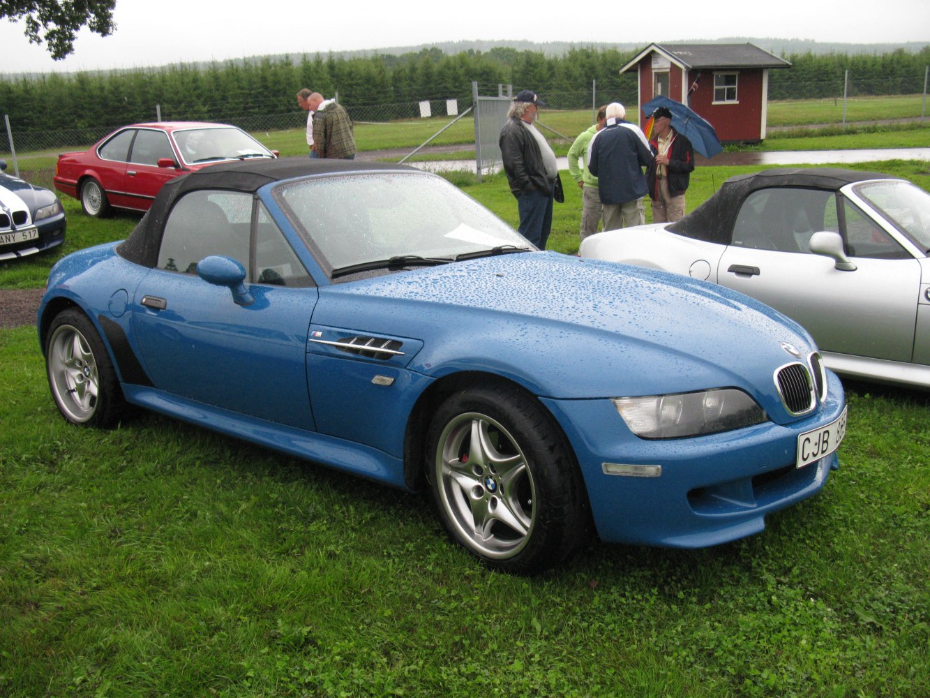 Blue roadster convertible with soft top and sporty side vents