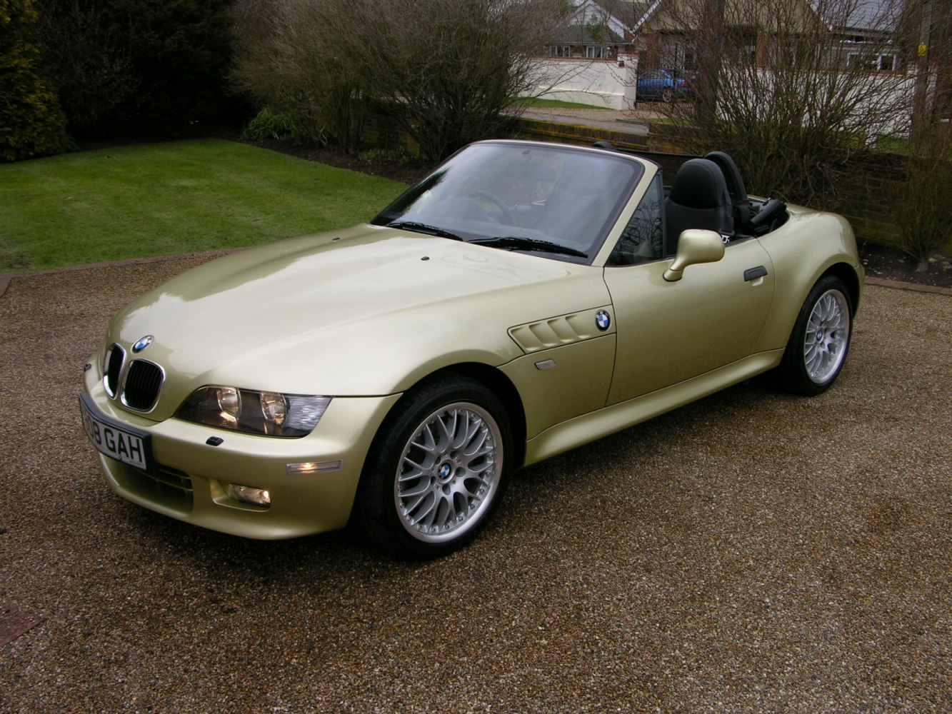 Front-side view of gold convertible with sporty alloy wheels