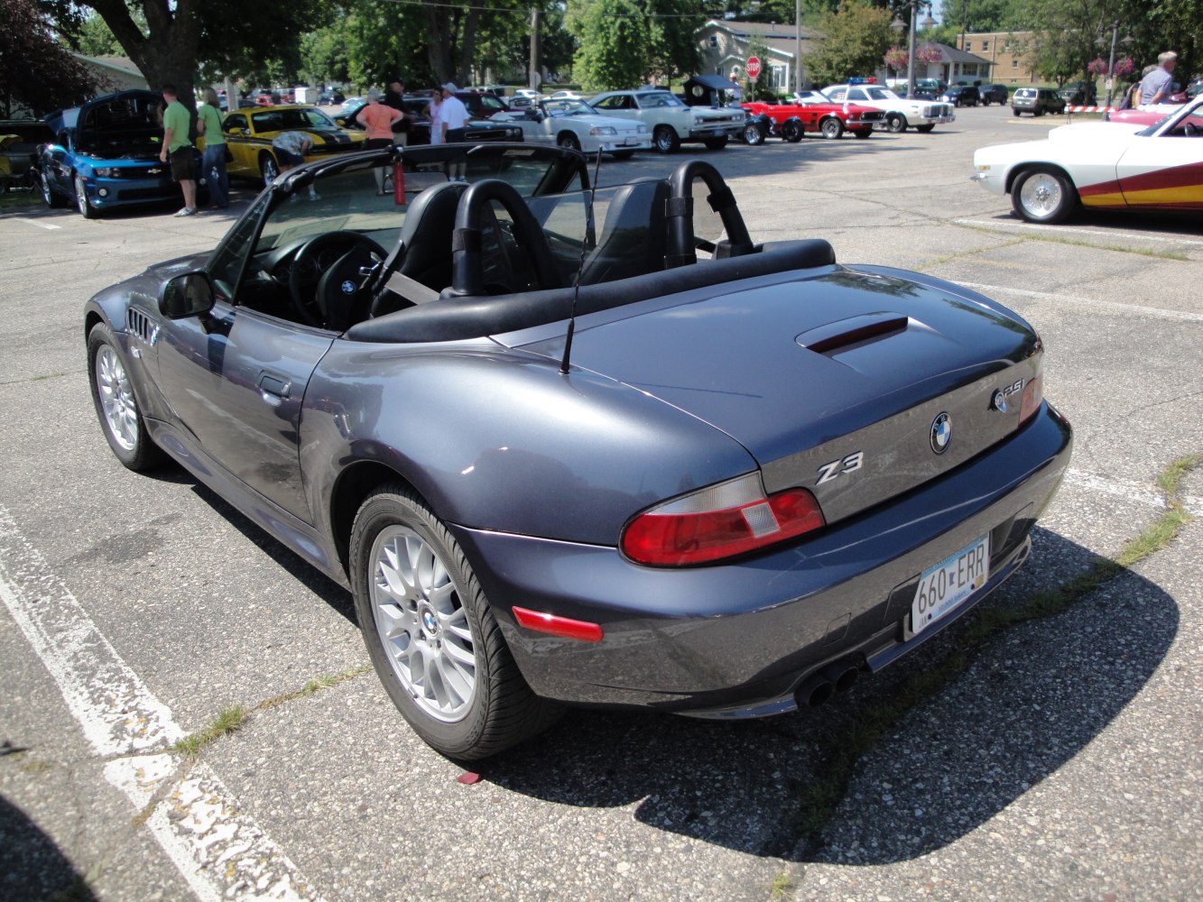 Convertible roadster rear with dual roll bars and sleek design.