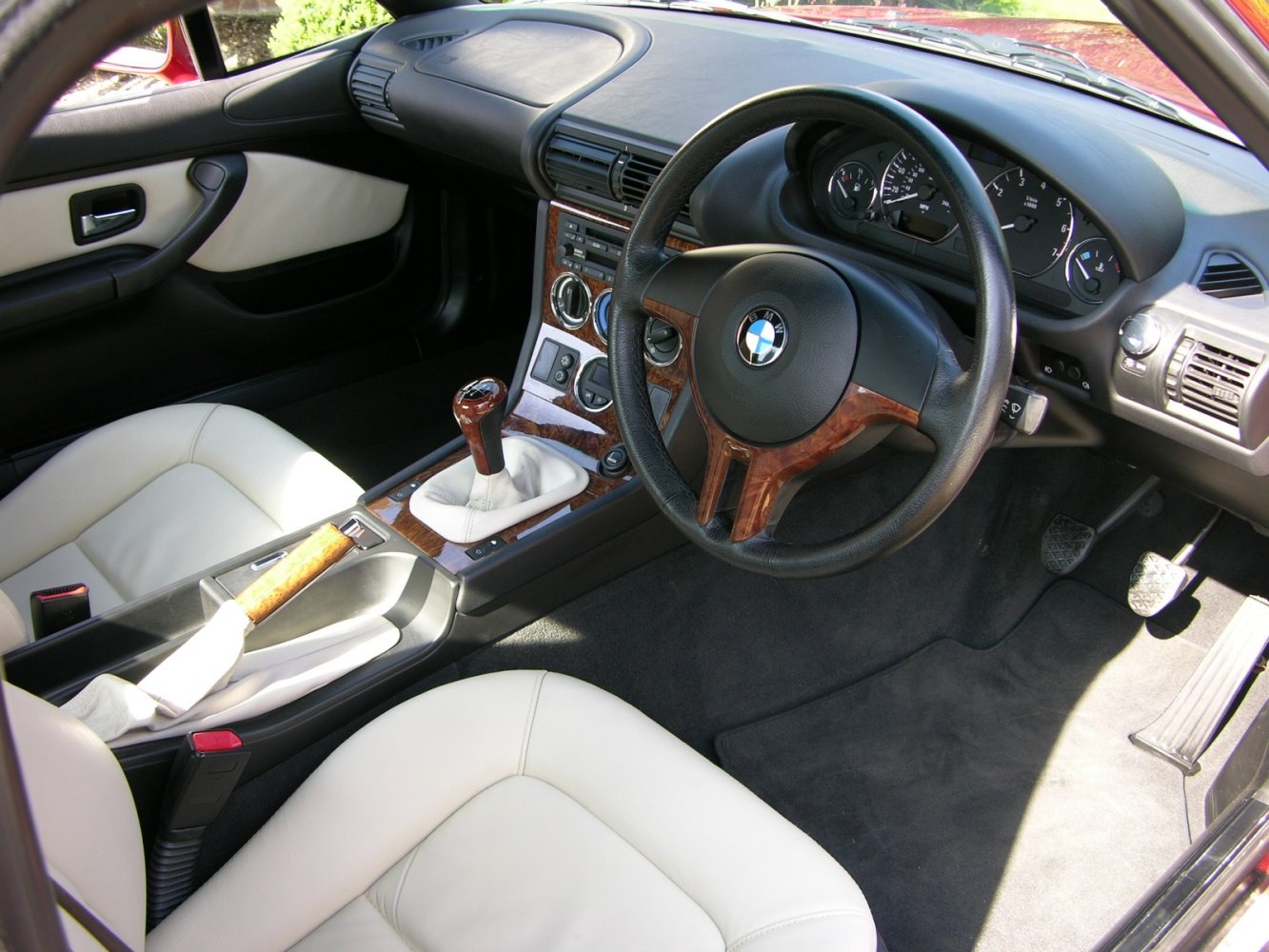 Manual transmission interior with wood trim and analog gauges