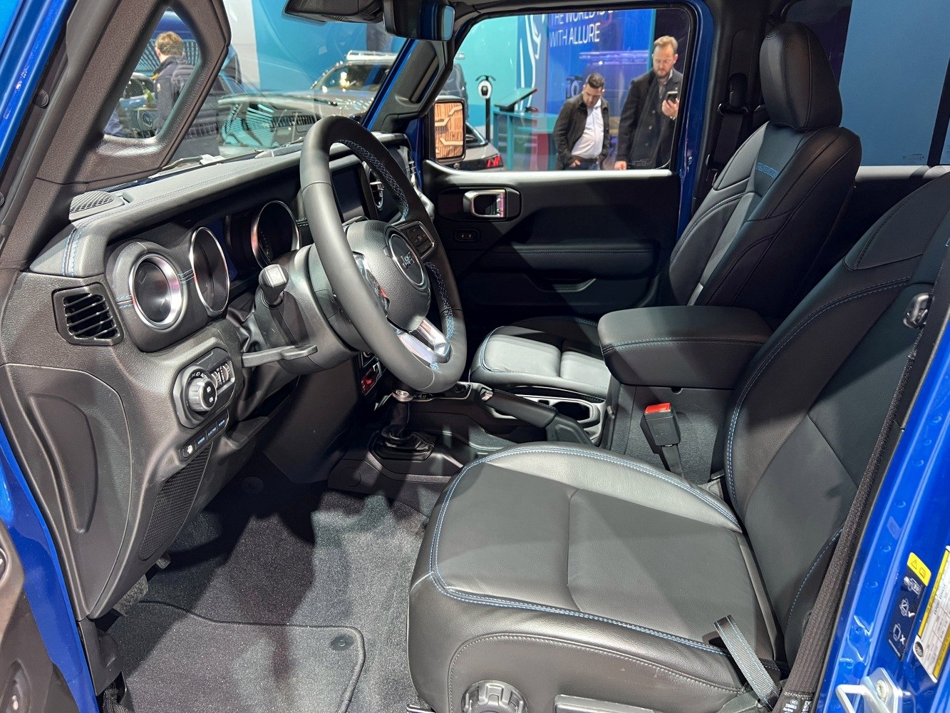 Black leather seats and dashboard with steering wheel and controls.