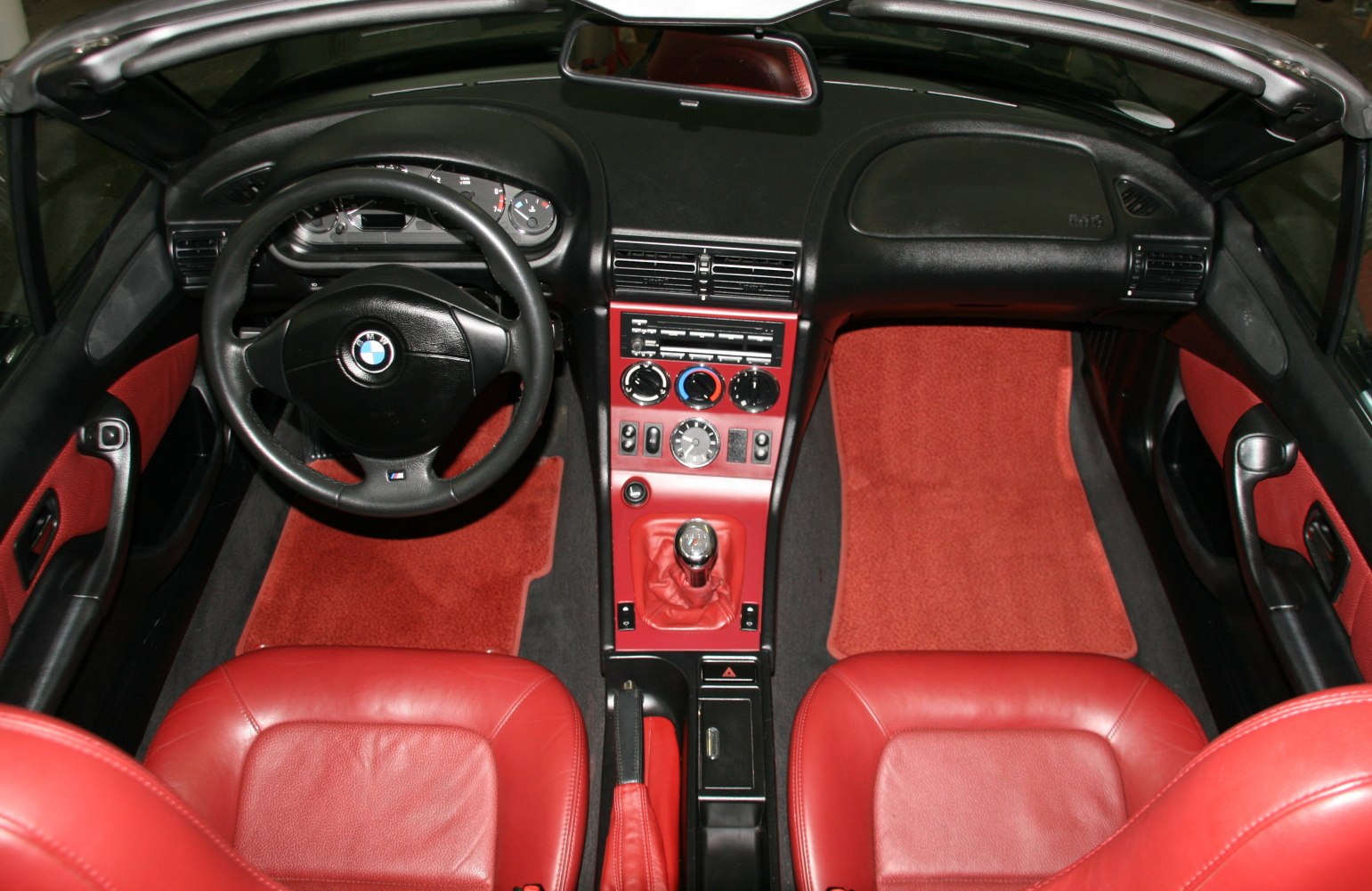 Red leather seats, manual gear shift, classic dashboard layout