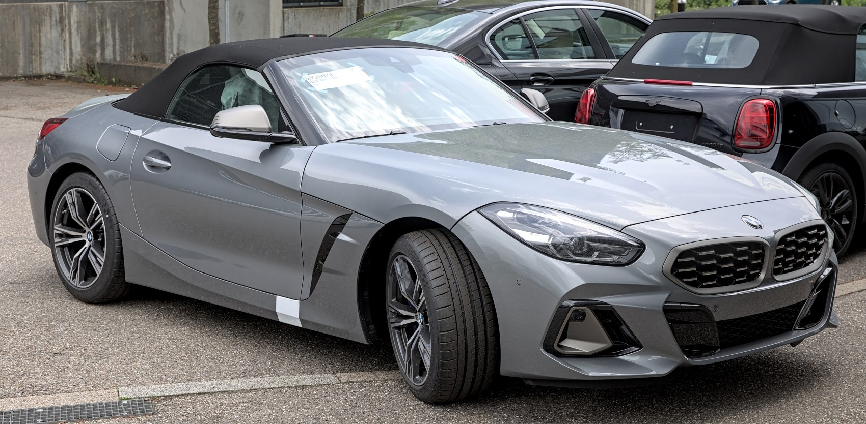 Front-side view of a sleek convertible with signature headlights and grille.