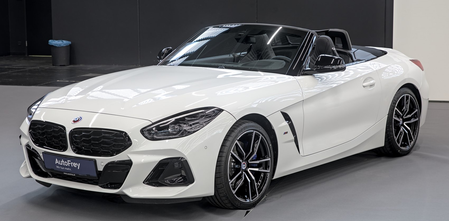 White convertible sports roadster with sleek design and modern alloy wheels