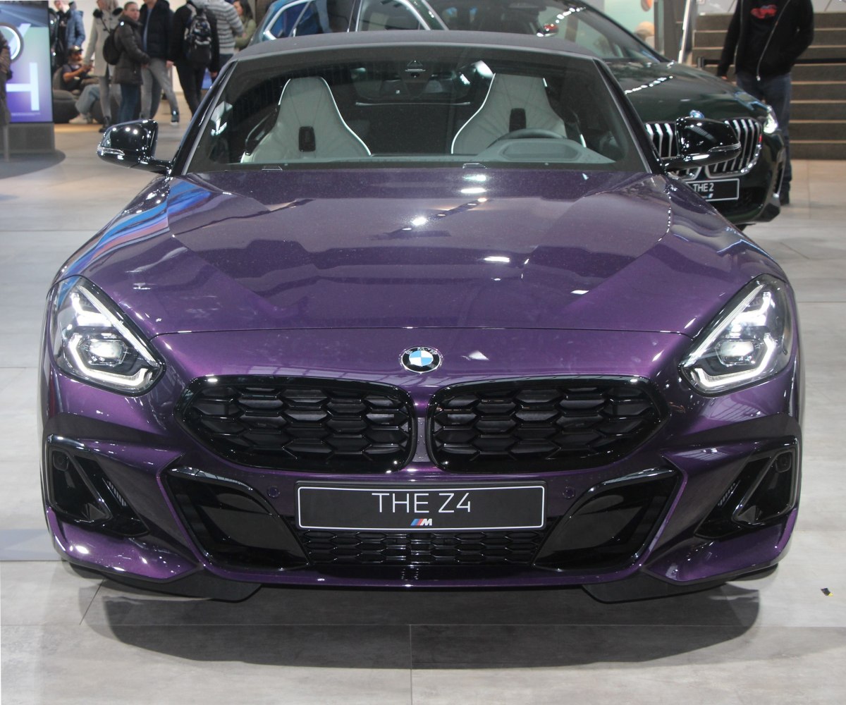 Close-up front view with black honeycomb grille and LED headlights