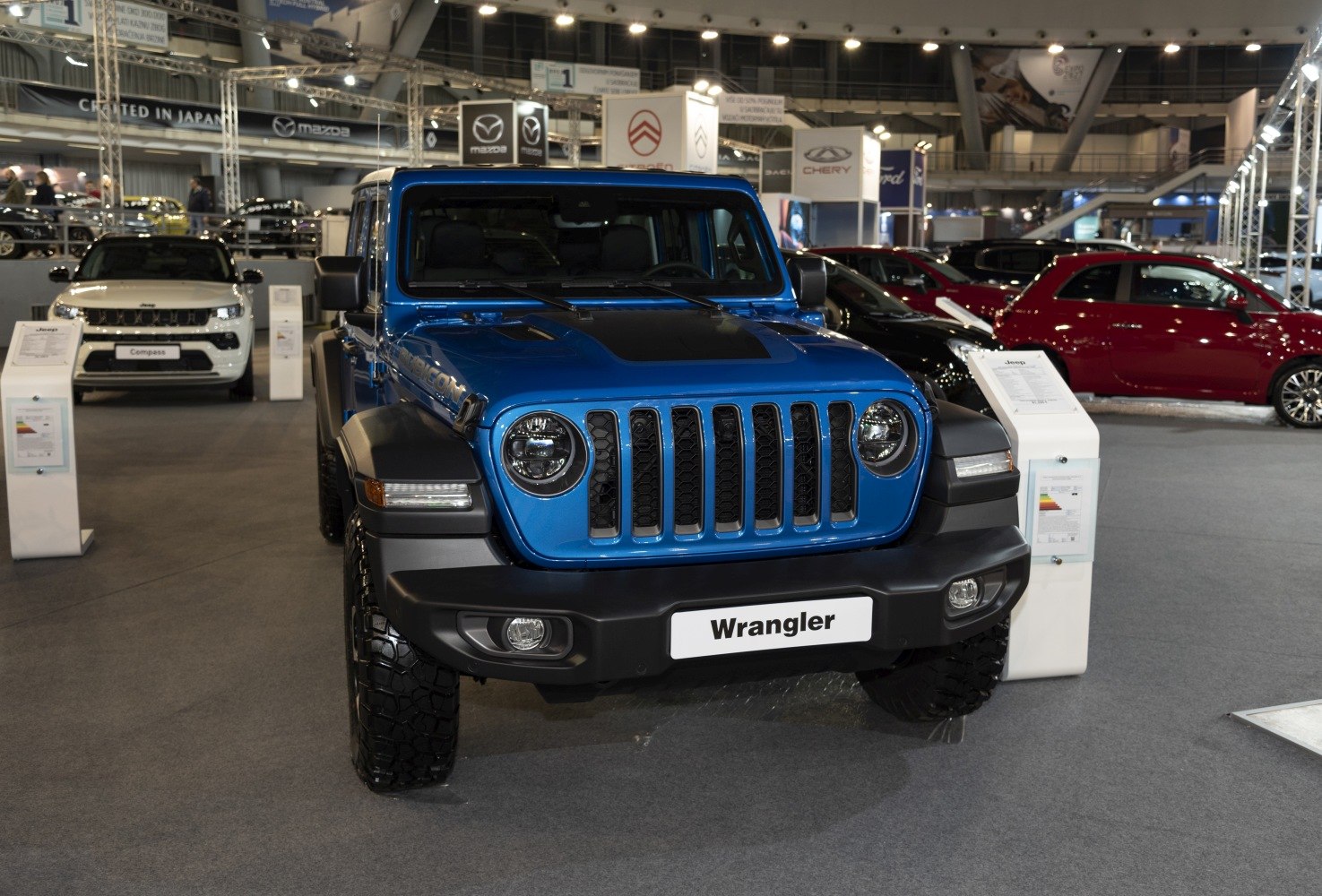 Blue off-road SUV front view with round headlights and seven-slot grille