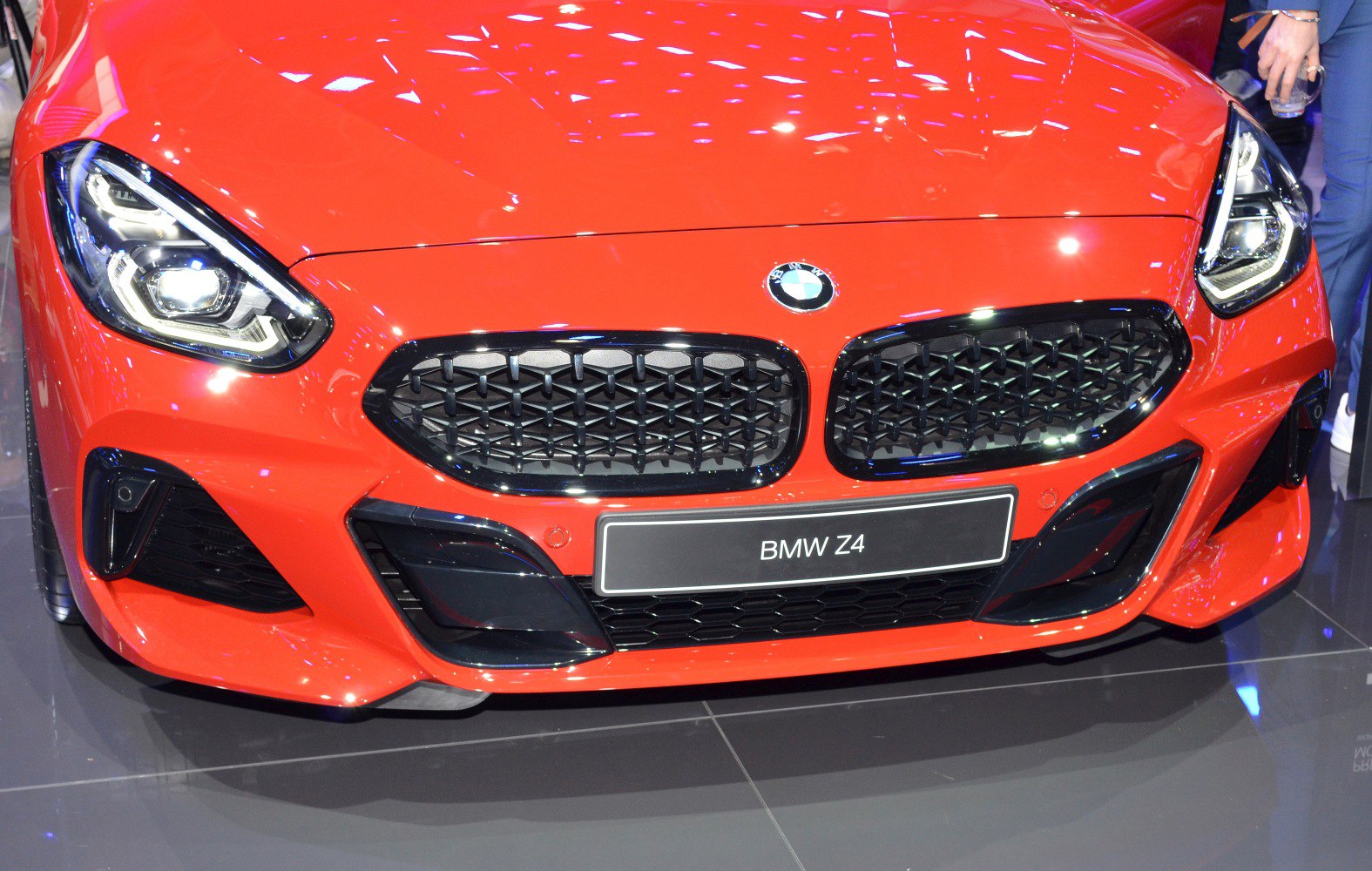 Front grille and modern headlights of a red sports car