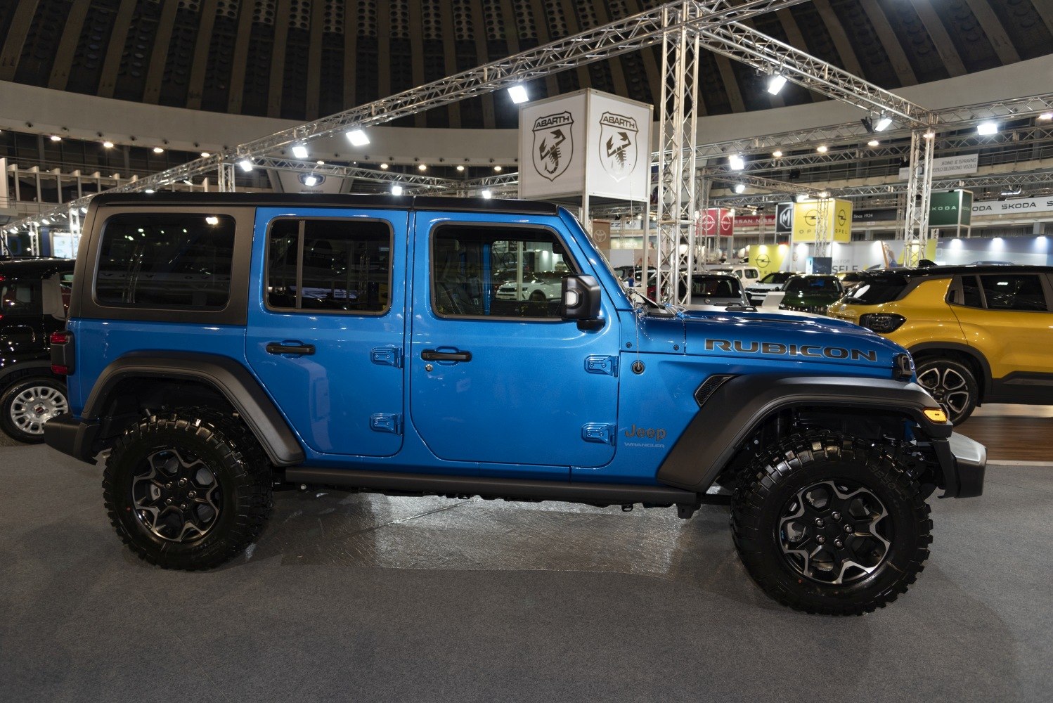 Side view of blue 4-door SUV with off-road tires and black fender flares