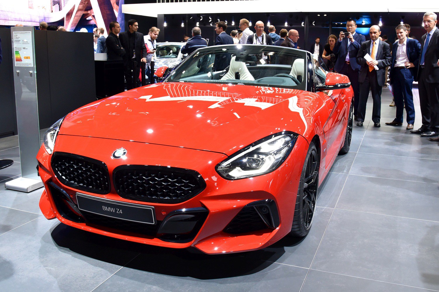 Red convertible sports car front with distinctive grille and LED headlights