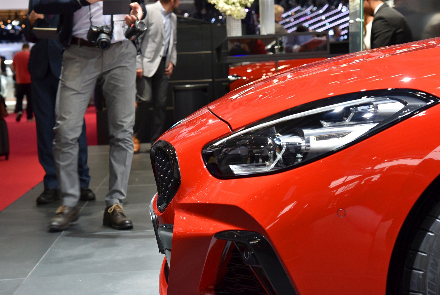 Close-up view of a sports car headlight and front grille.
