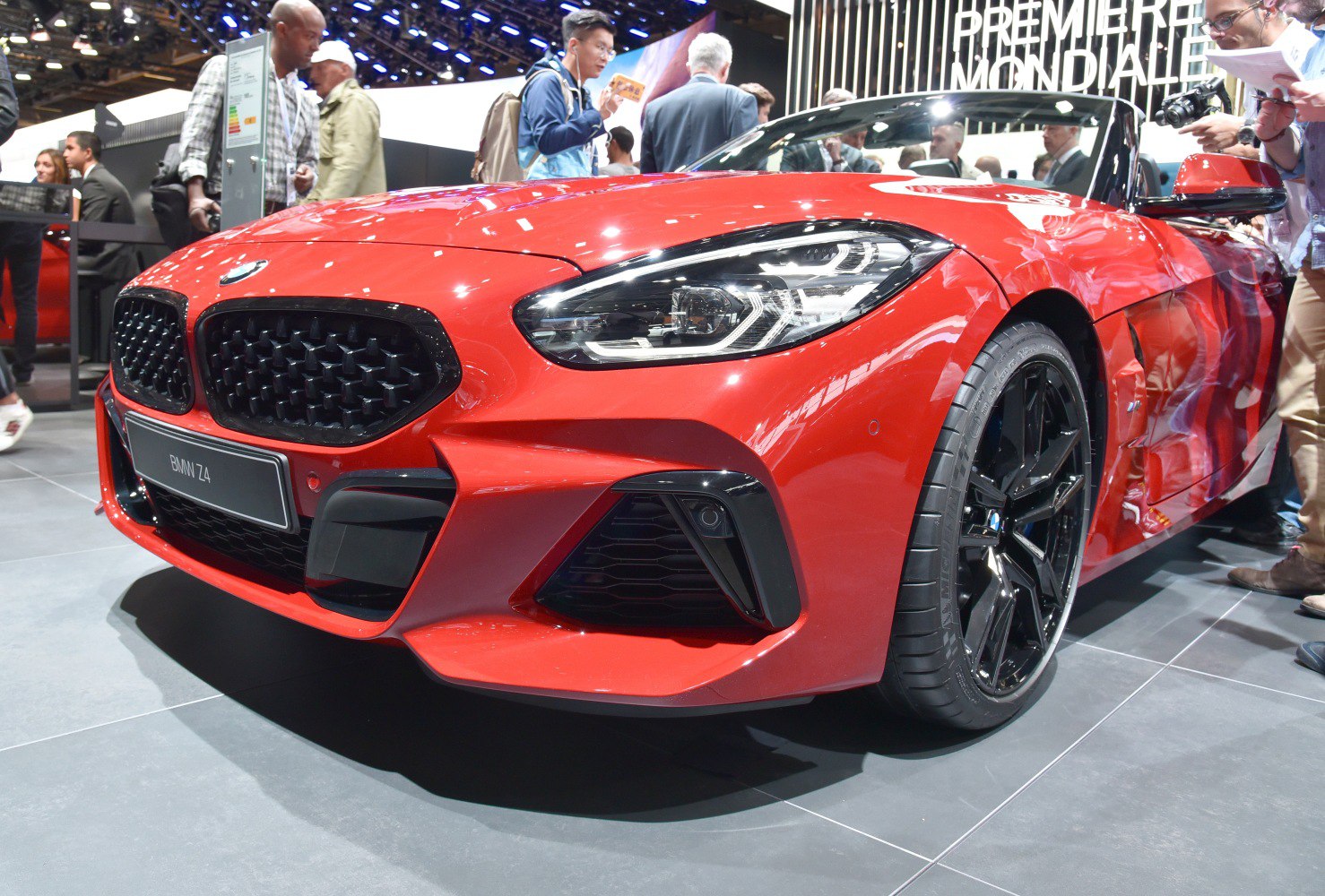 Sporty red roadster front with black grille and alloy wheels
