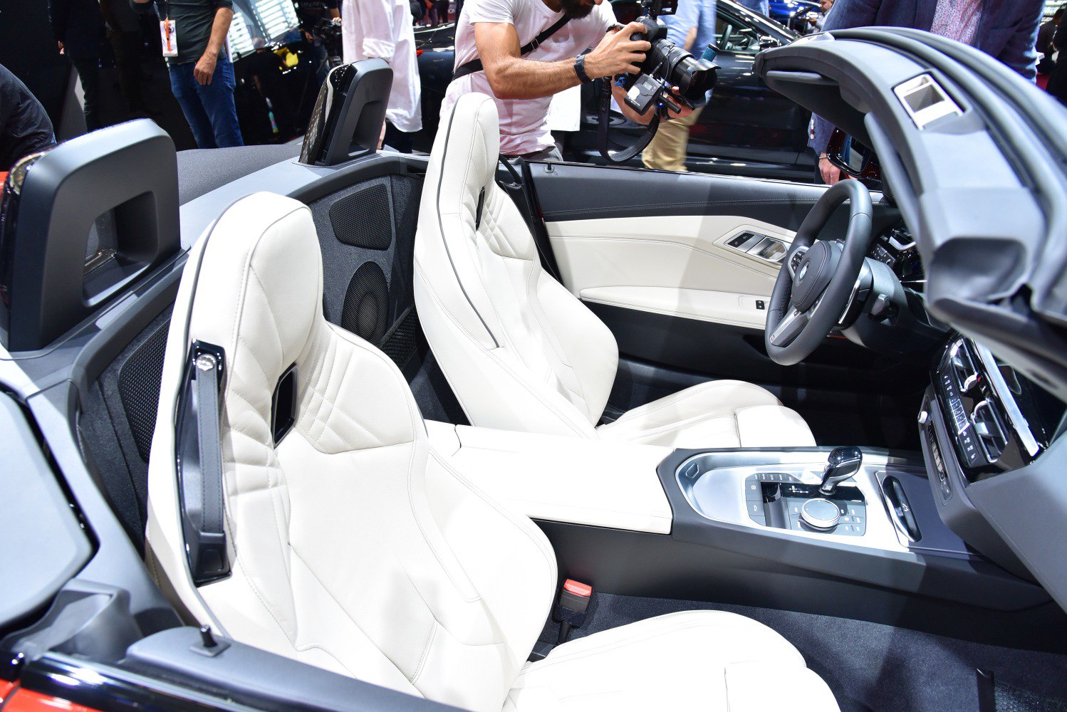 White leather bucket seats and modern central console with gear shifter