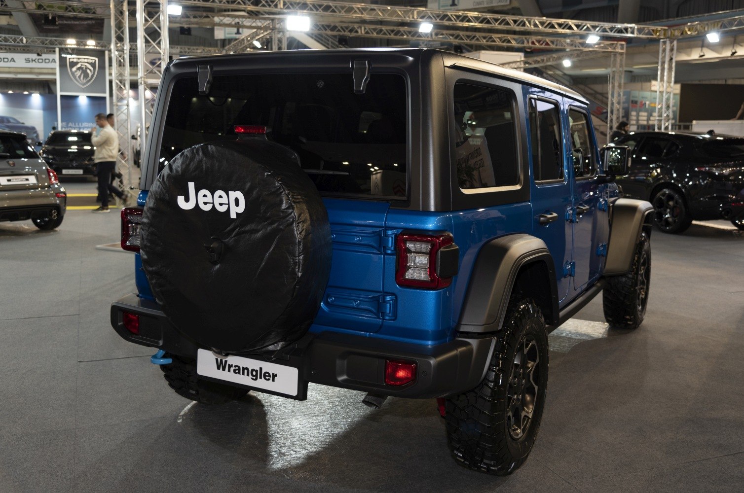 Rear view of 4-door SUV with spare tire cover and off-road tires