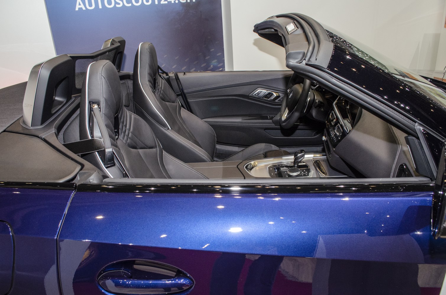 Convertible sports car interior with leather seats and advanced center console