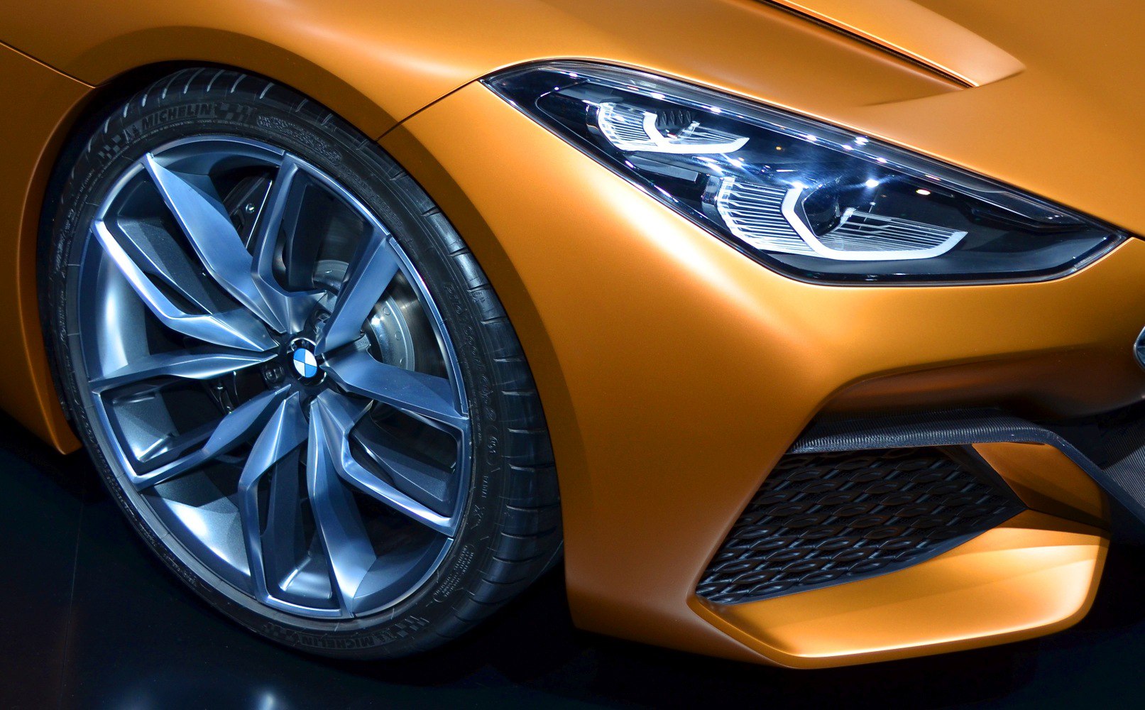 Close-up of alloy wheel and modern headlight design